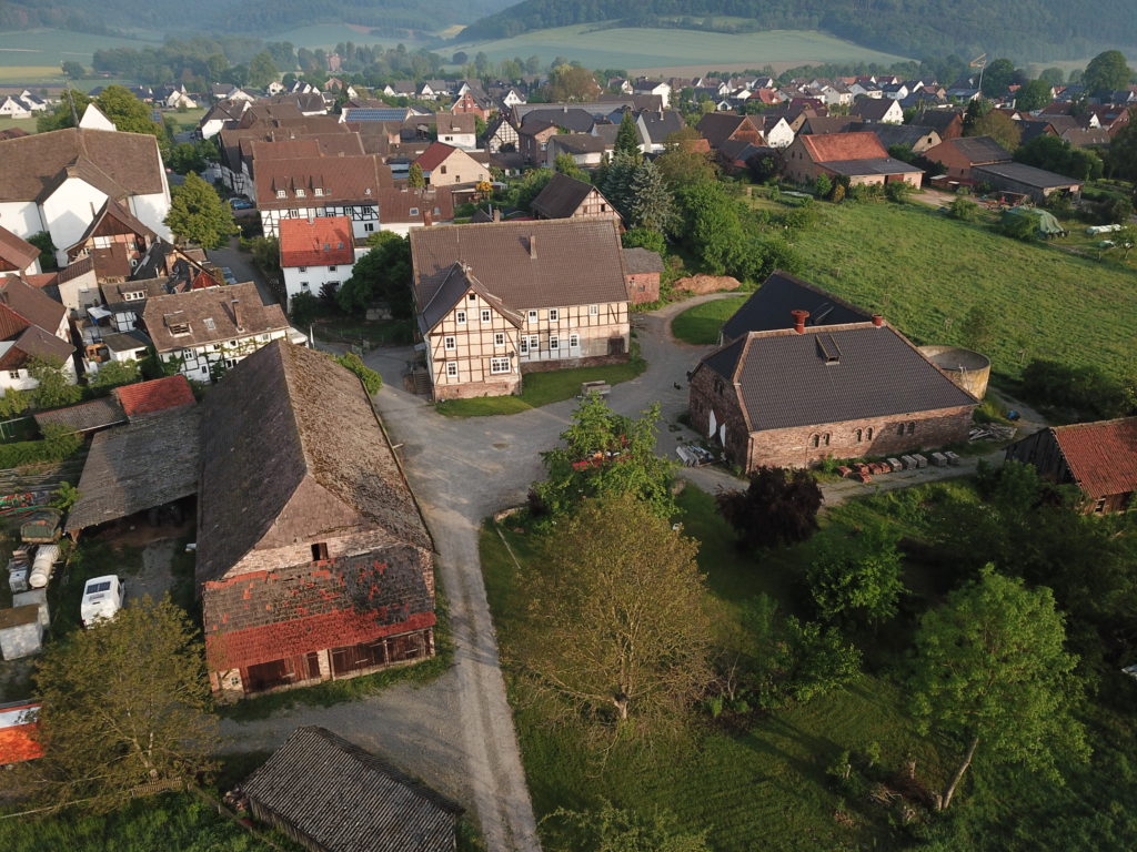 two big barns and the main house in the middle